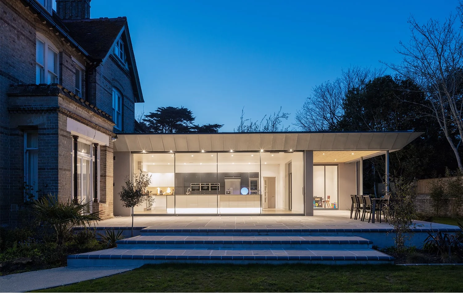 FineLine sliding glass doors across a contemporary extension at dusk