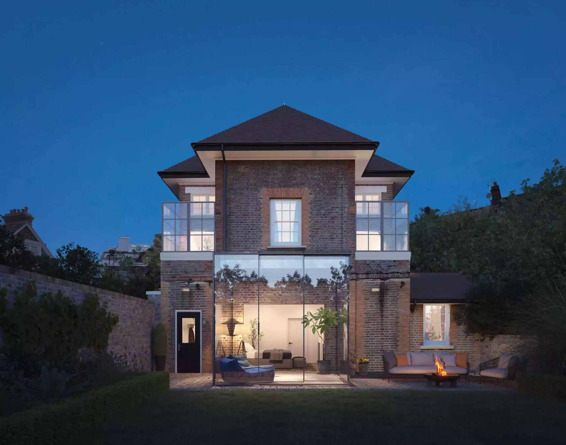 Original Design Studio image of a house at dusk with illuminated glass extensions