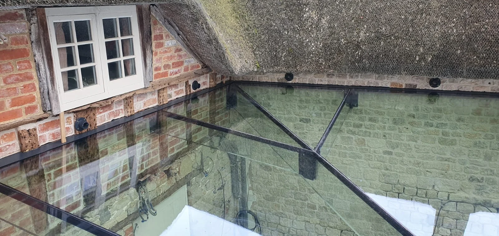 Structural glass roof connecting the buildings at Home Farm